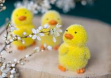 dziecko robiące kurczaczka wielkanocnego z farby i piórek